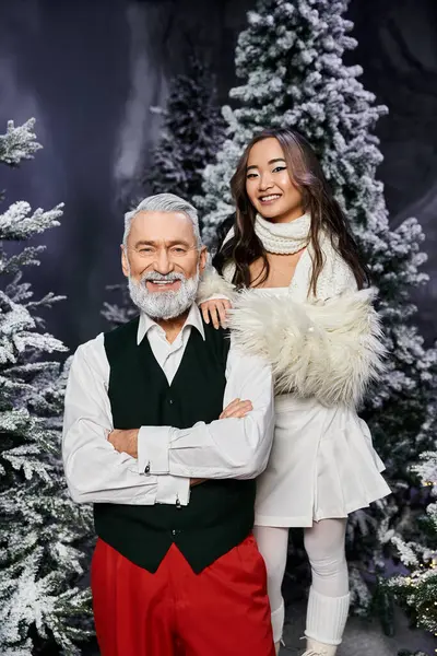 A happy couple shares a festive moment in a snowy, magical winter landscape. — Stock Photo