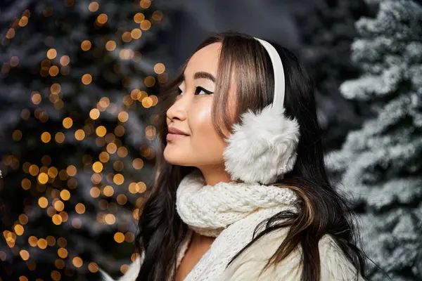 She embraces the holiday spirit with cozy attire and cheerful surroundings filled with lights. — Stock Photo