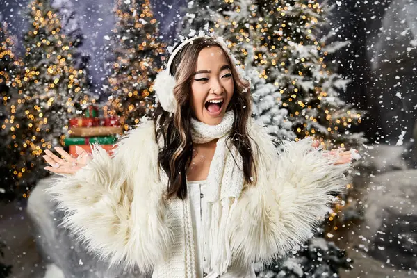 A joyful moment in a snowy setting as a woman revels in the holiday spirit among trees. — Stock Photo