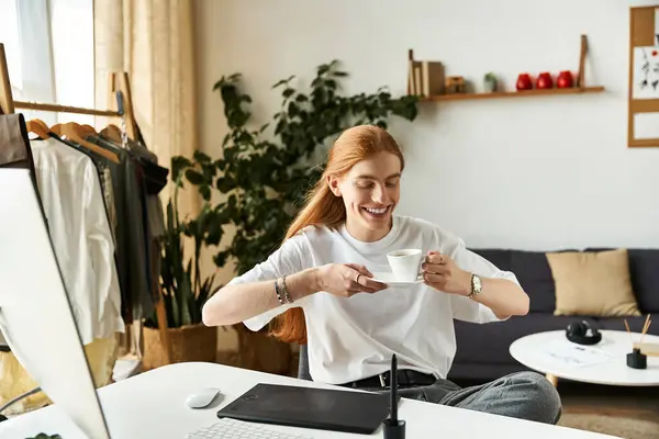 A young man relaxes and savors a warm drink while sitting in a bright, inviting room. — Stock Photo