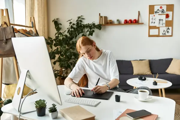 A creative individual focuses intently on digital art, surrounded by calm ambiance and greenery. — Stock Photo