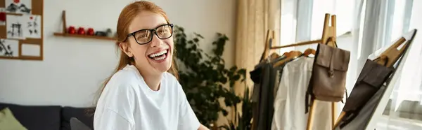 A young man is happily engaged in a creative task surrounded by artistic materials. — Stock Photo