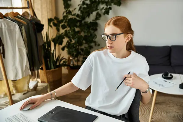 A young man explores creative ideas in his plant filled, modern workspace. — Stock Photo