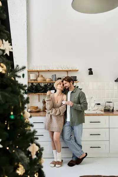 A couple shares a tender moment together in their beautifully decorated kitchen at home. — Stock Photo