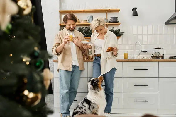 A couple enjoys a delightful breakfast together in their bright kitchen with their pet dog nearby. — Stock Photo