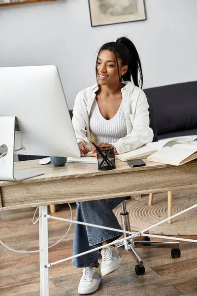 A young beautiful woman reviews study materials while working diligently from her cozy home office. — Stock Photo