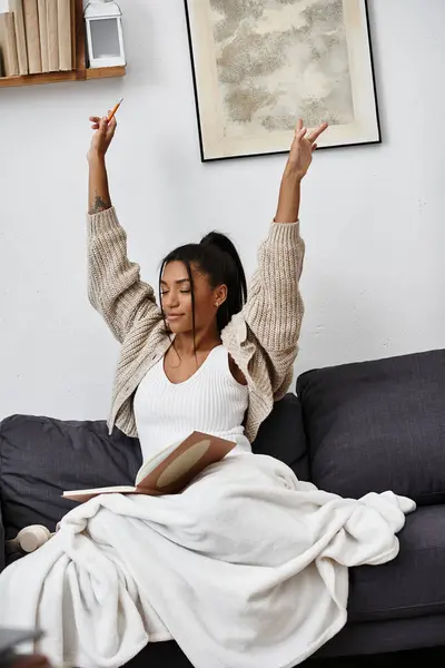 The young woman expresses joy and accomplishment while studying remotely from her home. — Stock Photo