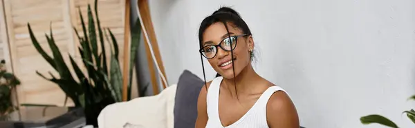A beautiful young woman is engaged in remote studying at home in a stylish setting. — Stock Photo
