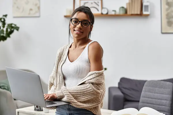 A young woman engages in her remote studies at home, showcasing a comfortable workspace. — Stock Photo