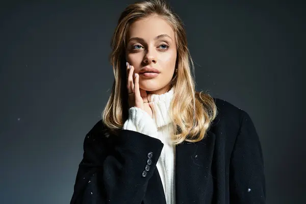 A young woman stands gracefully, showcasing winter fashion with a contemplative look in her eyes. — Stock Photo