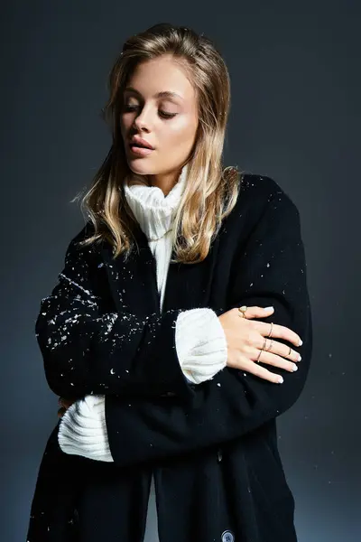 A young woman stands gracefully, enjoying the serene winter atmosphere and soft snowflakes. — Stock Photo