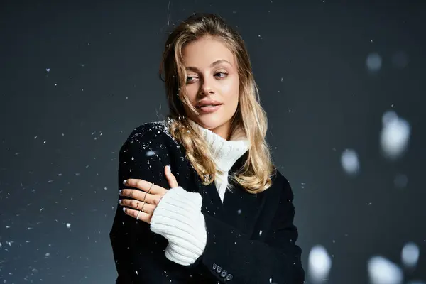 A young beautiful woman expresses joy while snowflakes gently fall around her in a serene moment. — Stock Photo