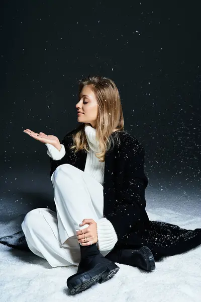 In a serene moment, a young woman feels snowflakes gently falling around her in winter attire. — Stock Photo