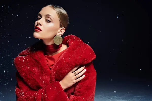 A stylish young woman in a bright red fur coat poses beautifully against the snow. — Stock Photo