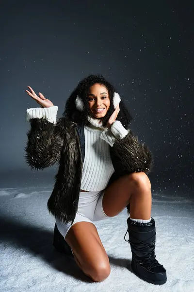 An elegant brunette woman in earmuffs poses in a faux fur jacket, embracing winter fashion with style. — Stock Photo