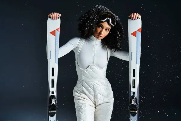 An elegant brunette woman models chic ski attire in a captivating studio, embodying winter fashion trends. — Stock Photo
