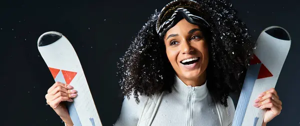 A beautiful brunette woman exudes confidence in a ski suit, radiating winter fashion vibes in a studio. — Stock Photo