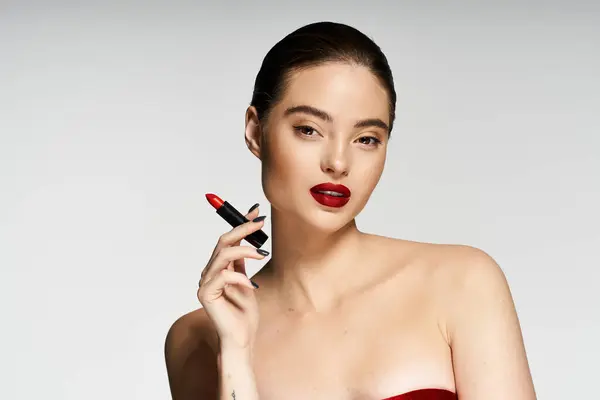 A graceful woman showcases a bold red lip color, embodying elegance and beauty effortlessly. — Stock Photo