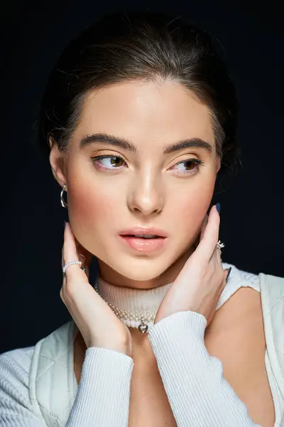 The lovely woman delicately touches her face, exuding a sense of calm and poise. — Stock Photo