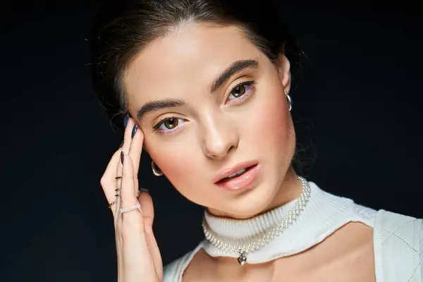 Una donna splendida mette in mostra la sua grazia mentre premurosamente appoggia la mano sulla sua testa. — Foto stock