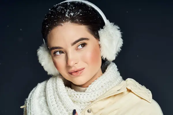 A woman radiates warmth and confidence amid falling snow while bundled in winter clothing. — Stock Photo