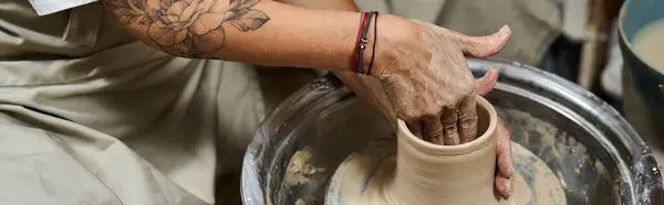 A skilled woman molds clay into a beautiful vessel in a tranquil pottery studio. — Stock Photo