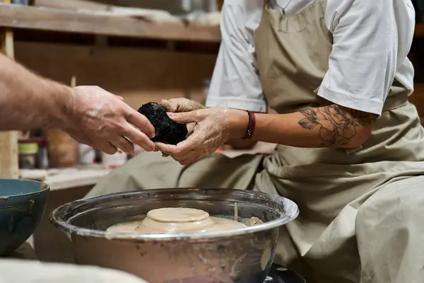 Hands expertly shape clay on a spinning wheel while an artist guides the process. — Stock Photo