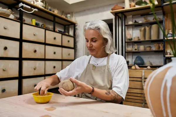 The talented artist molds clay with focused hands, immersed in the joy of creation in her studio. — Stock Photo
