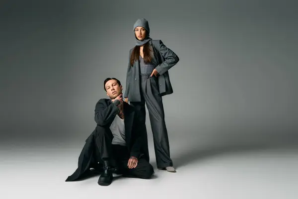 A fashionable young duo showcases contemporary clothing with a confident and artistic flair. — Stock Photo