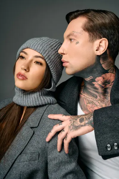 Two fashionably dressed young individuals showcase style and charisma with a serene expression. — Stock Photo