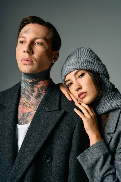 A young attractive couple showcases their fashion choices in a modern, artistic setting. — Stock Photo