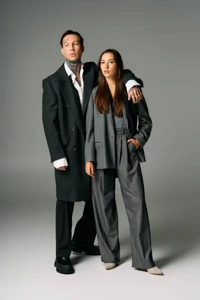 A young and attractive duo stands side by side, exuding elegance and modern fashion trends. — Stock Photo