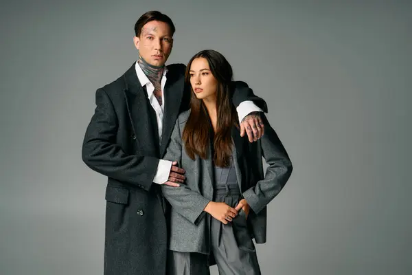 A young attractive couple poses together, exuding confidence and creativity in fashion. — Stock Photo