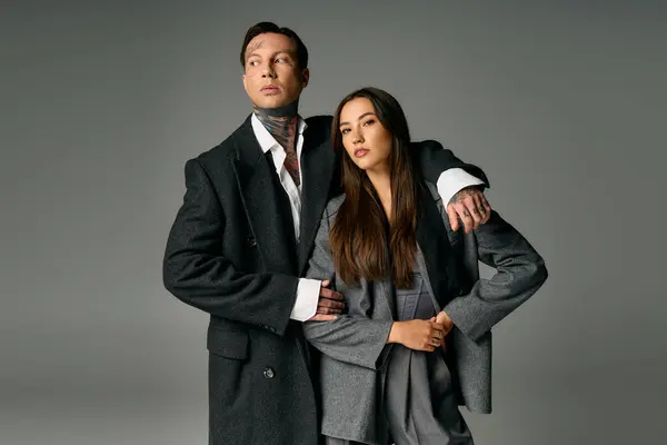 A fashionable young couple poses elegantly, highlighting their trendy attire and captivating style. — Stock Photo