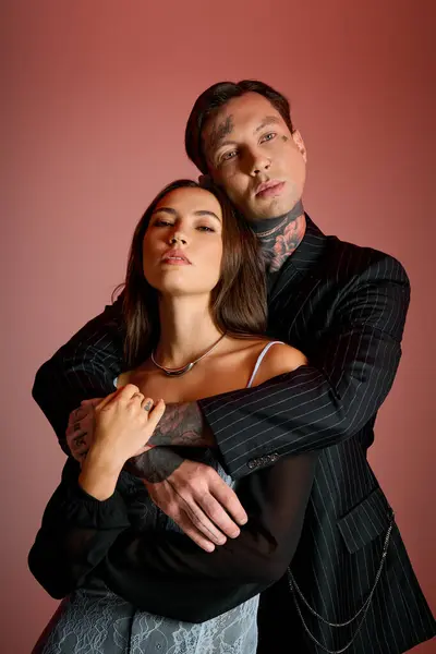 A young couple embraces joyfully, showcasing their fashionable outfits and confident expressions. — Stock Photo