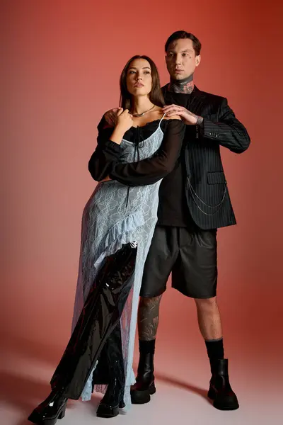A young couple showcases modern fashion with confidence in bold, eye catching attire. — Stock Photo