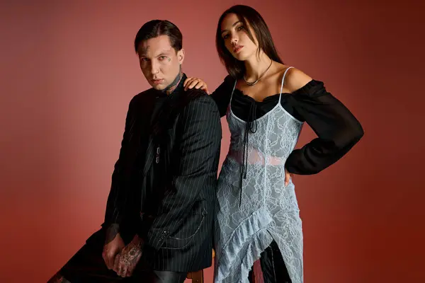 A fashionable young duo showcases their unique styles with confidence in a creative space. — Stock Photo