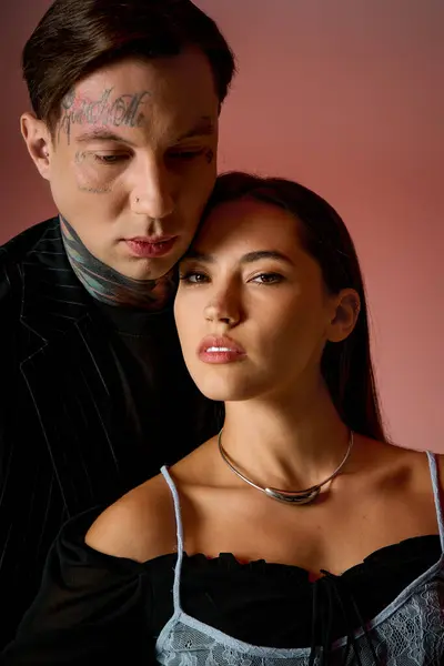 A young couple stands close, exuding confidence and elegance, showcasing their unique style. — Stock Photo