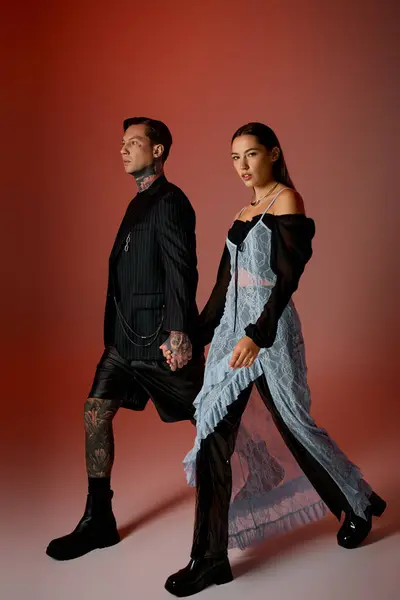 A young couple strolls together, showcasing modern fashion and vibrant energy in a striking setting. — Stock Photo