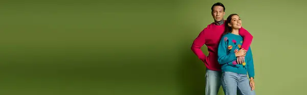 A couple stands closely, smiling joyfully, showcasing their colorful outfits and connection. — Stock Photo