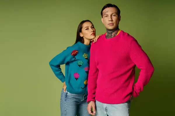 Attractive young individuals showcase unique sweaters while expressing their style and charisma. — Stock Photo