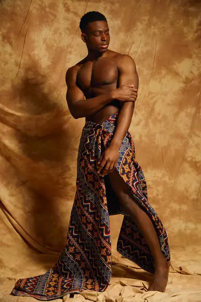 A youthful, attractive African American man stands confidently, showcasing his physique. — Stock Photo