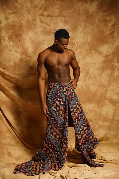 A young and handsome African American man stands confidently, showcasing his toned physique. — Stock Photo