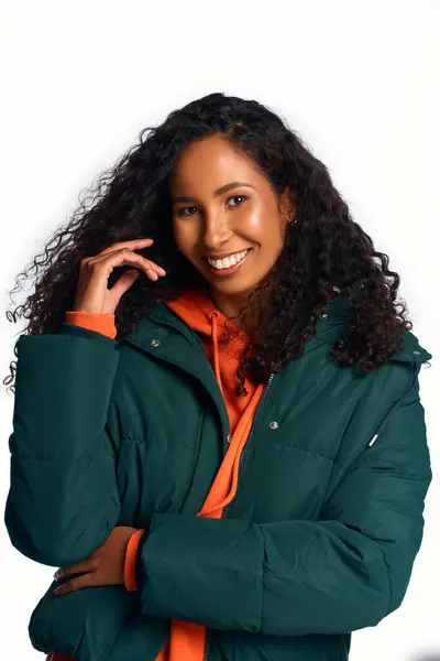 Brightly lit space highlights a joyful woman who radiates warmth and style in winter clothing. — Stock Photo