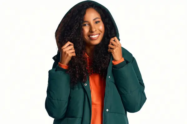 Beautiful woman with curly hair wears a stylish jacket while smiling warmly at the camera — Stock Photo