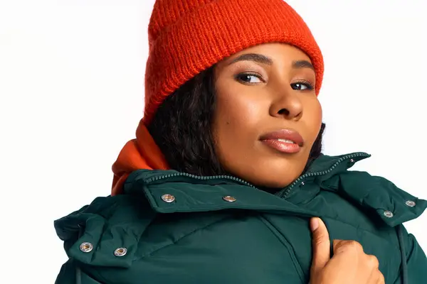 Young woman models vibrant winter attire with a playful expression, exuding charm and elegance. — Stock Photo