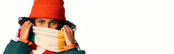 Captivating woman bundled in colorful layers, showcasing winter style in a bright setting. — Stock Photo