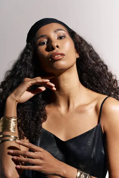 A woman exudes confidence and grace with stunning features in a professional studio setting. — Stock Photo