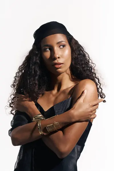 A captivating woman with curly hair embraces her beauty while wearing elegant accessories. — Stock Photo