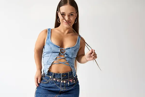 Stylish young woman with short stature poses confidently in denim attire, embodying diversity. — Stock Photo